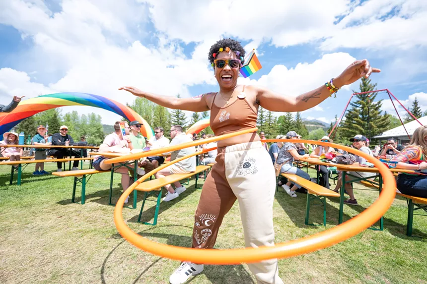 A woman hula hopping in a park during Breck Pride