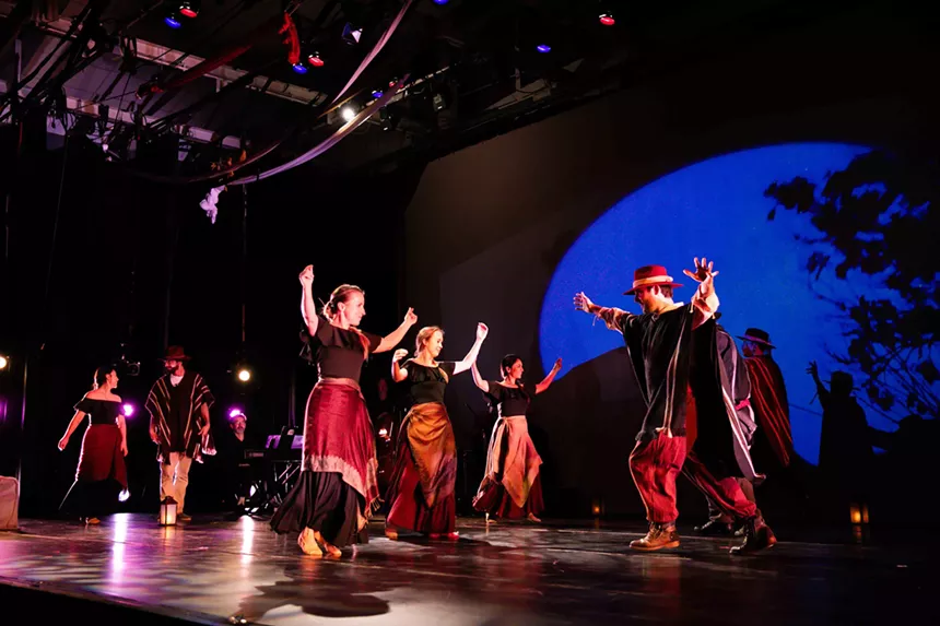 A dance troupe performs on stage.
