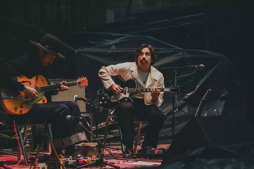 A photo of Hermanos Gutiérrez performing at Red Rocks.