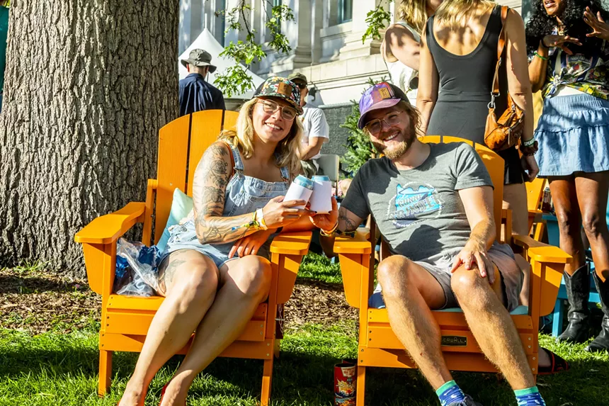 A couple enjoys a drink together in the VIP area on Saturday at Outside Festival.