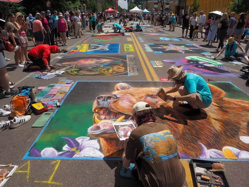 In Denver, people use chalk to create street paintings.