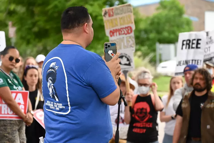 A man holds up a phone.