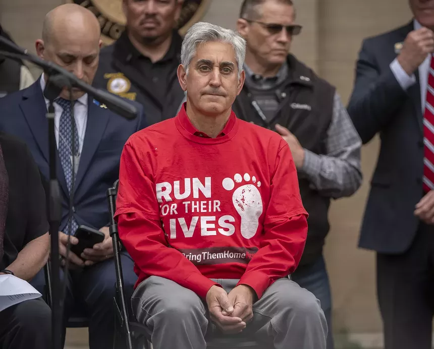 man in red shirt in crowd