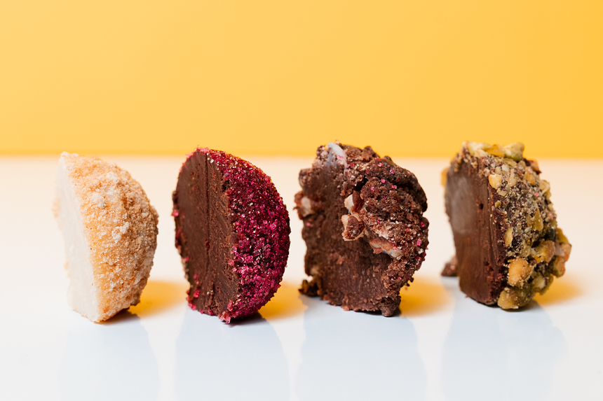 Four types of Bibamba truffles against a yellow backdrop