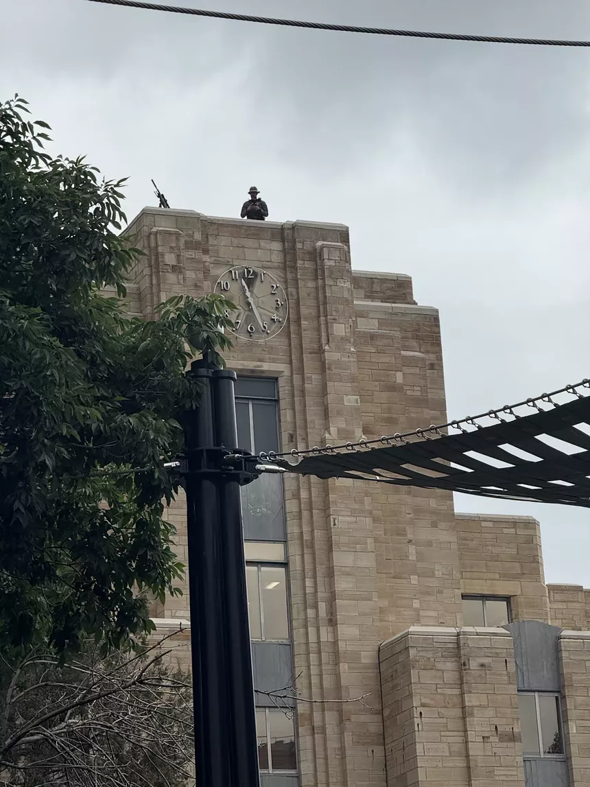 A sniper and his rifle are seen atop the historic Boulder Courthouse