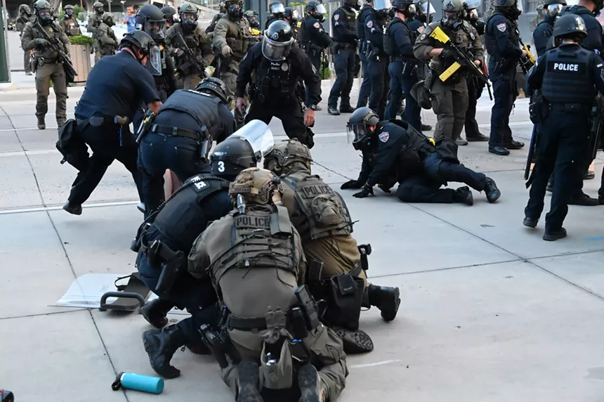 Police arrest people amid chaos.