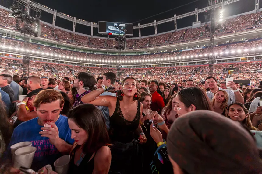 Fans were blowing bubbles to pass the time during a concert delay due to a severe thunderstorm in the area.
