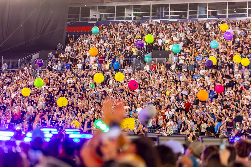 A photo of the crowd during a Coldplay performance at Empower Field at Mile High.