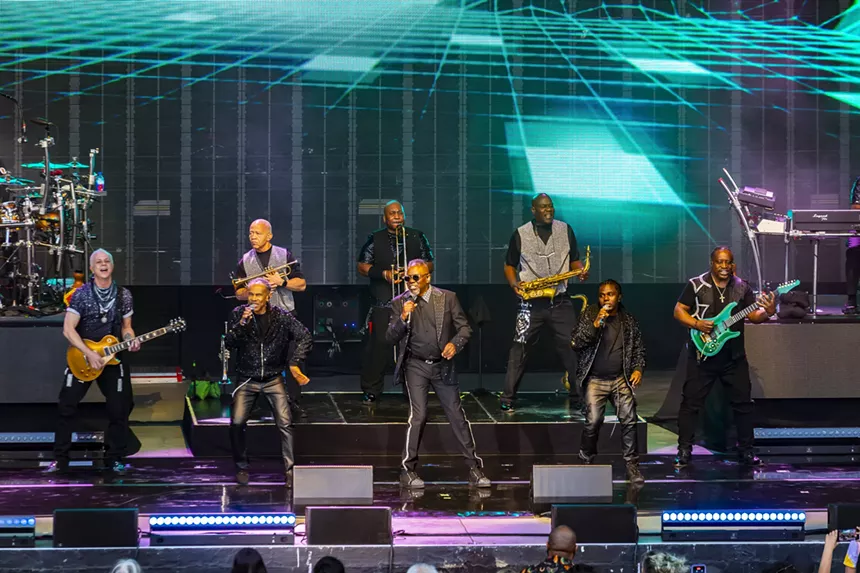 Members of Earth, Wind & Fire performing on stage.