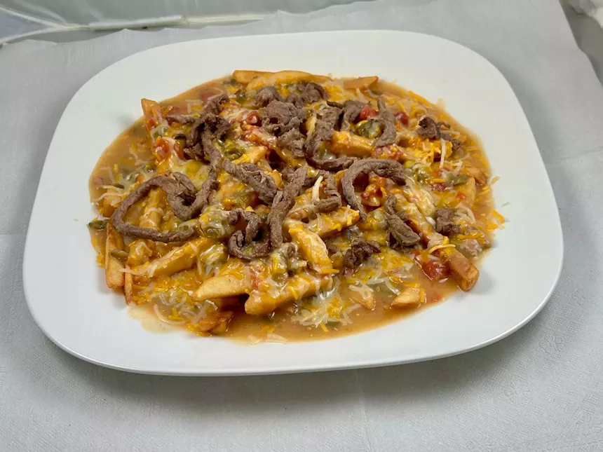Cripsy fries topped with grilled steak strips, melted cheese, and smothered in housemade green chile.