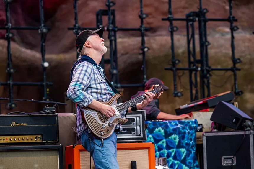 Jimmy Herring smiling and playing guitar