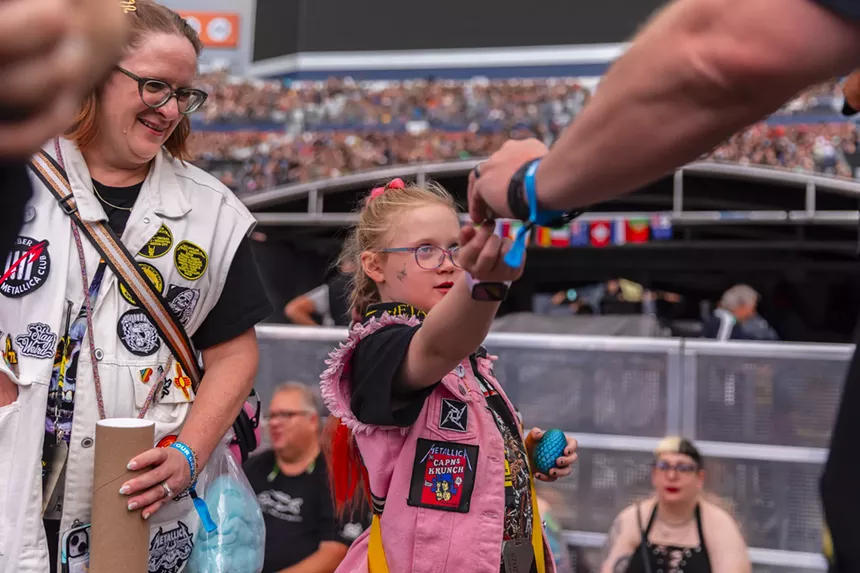 A young Metallica fan was handing out handmade buttons that featured her artwork.
