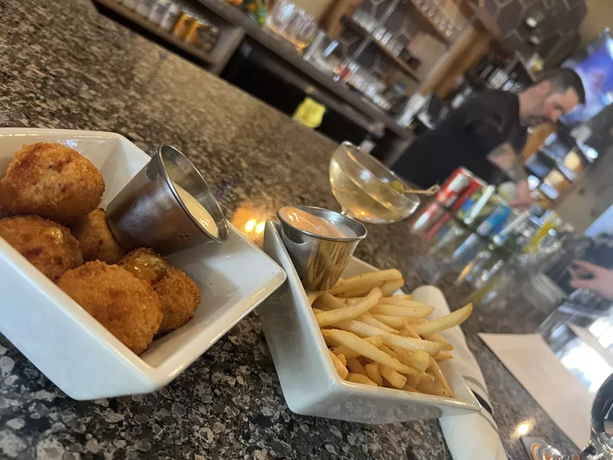 Cheese balls and fries on a table