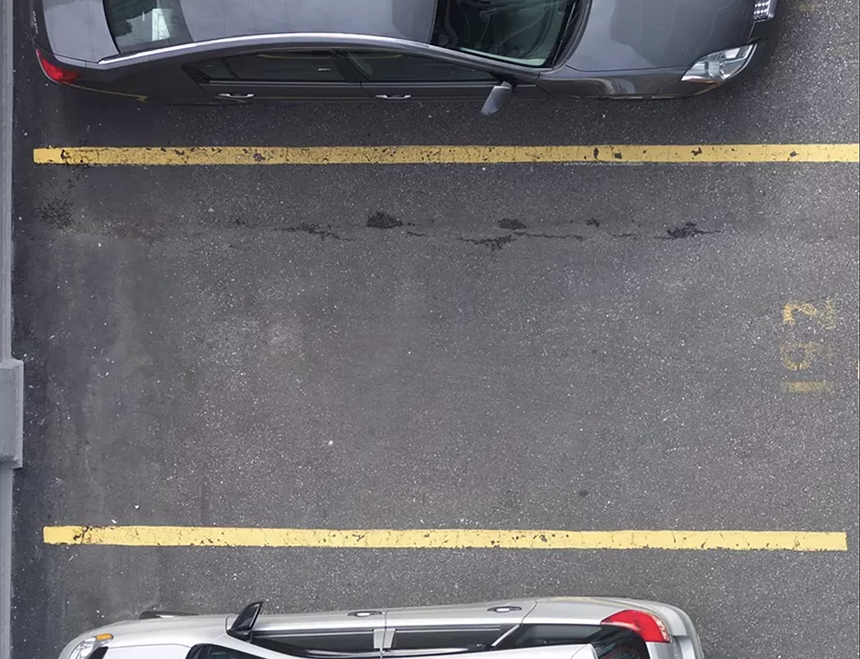 empty parking spot between two parked cars