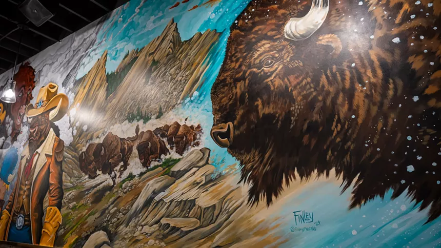 A portion of the mural painted by Josh Finley at the Boulder Pearl St. location.