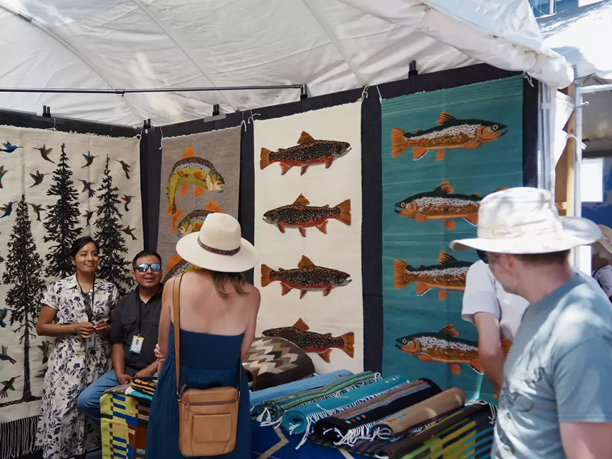 people browse art and talk to the artists