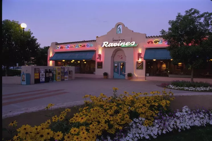 outside of restaurant with lights and flowers