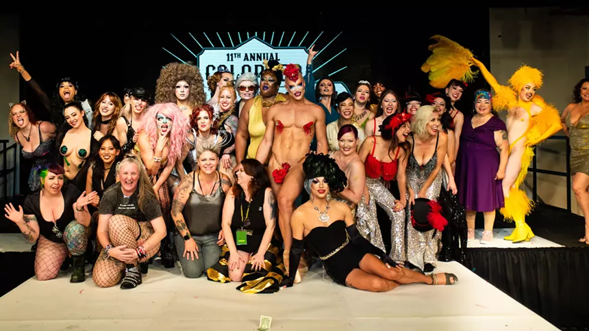 Burlesque performers pose together.