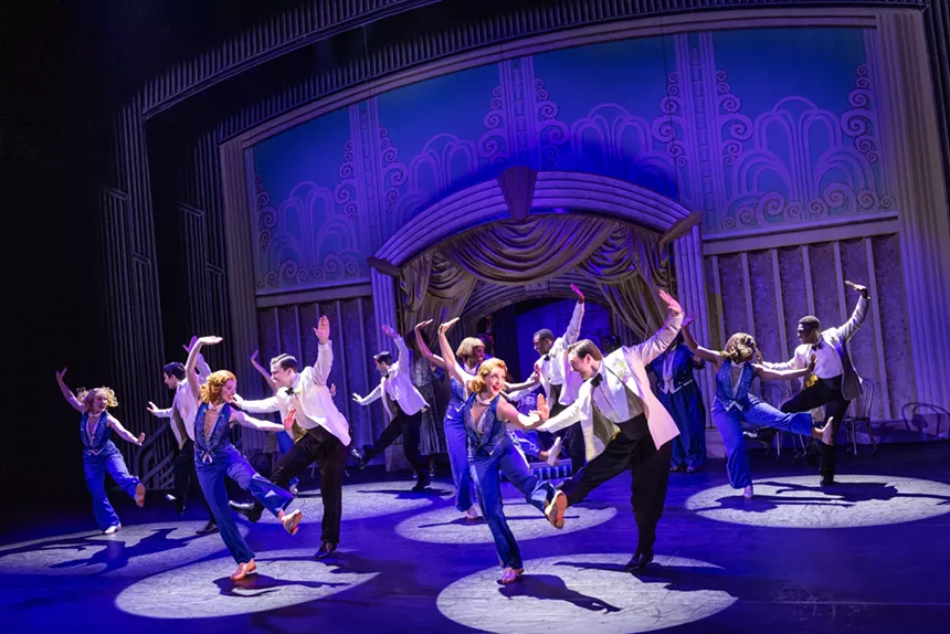 A musical theater ensemble performs a musical number.