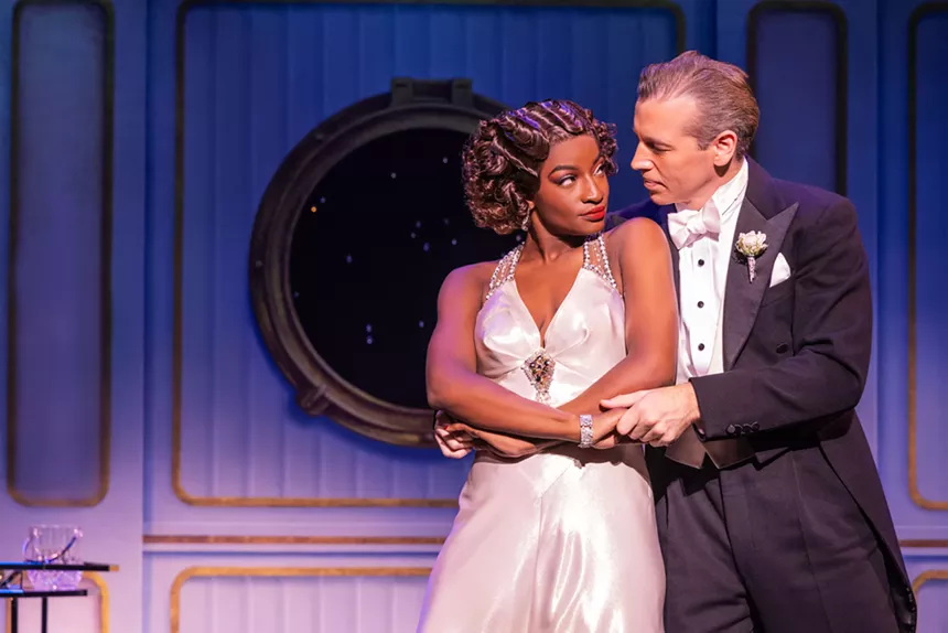 A romantic scene between a man and a woman on a boat in a musical.