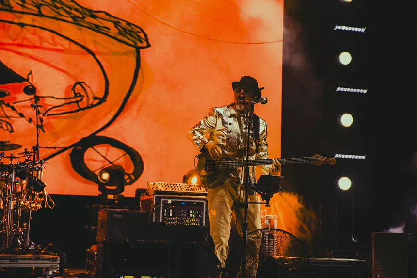 Les Claypool performing on stage at Red Rocks.