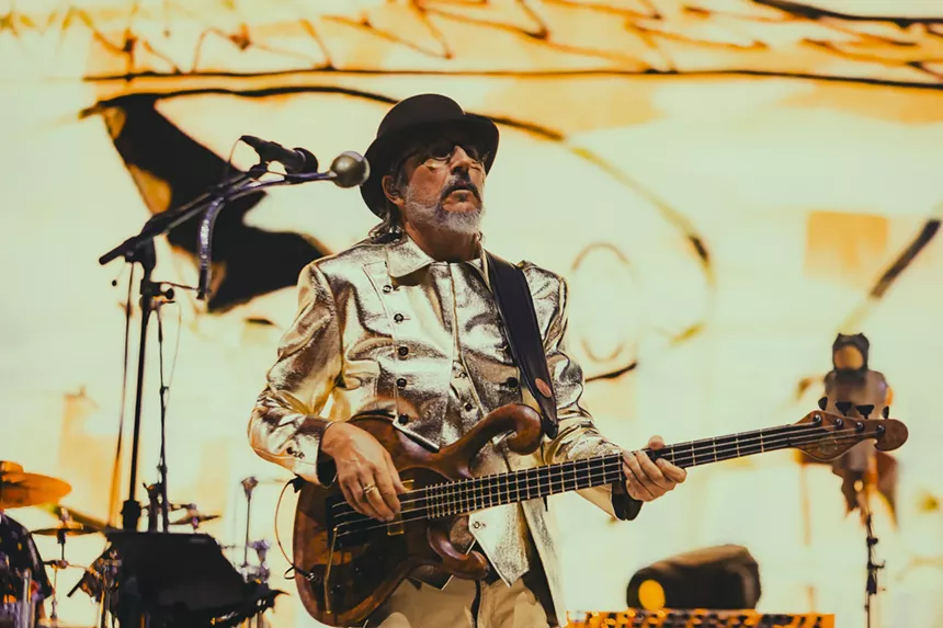 Les Claypool performing on stage at Red Rocks.