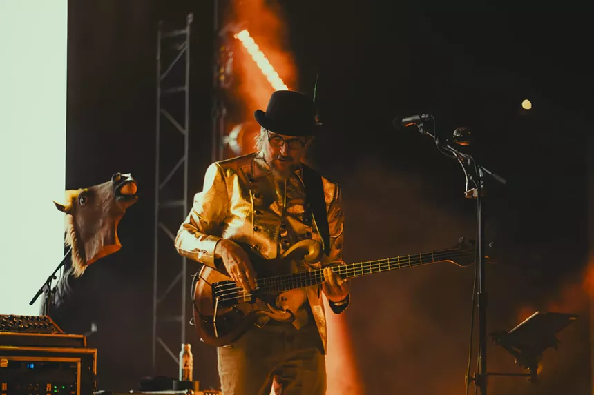Les Claypool performing on stage at Red Rocks.