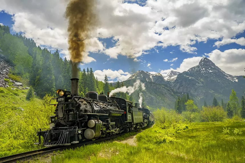 The Durango and Silverton Narrow Gauge Railroad train backdropped by mountains in the Weminuche Wilderness