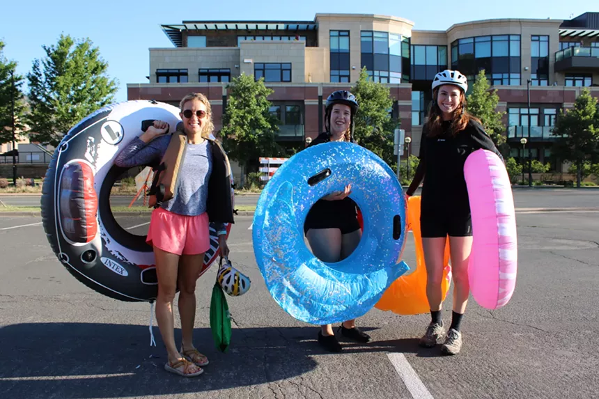 Three people hold tubes.