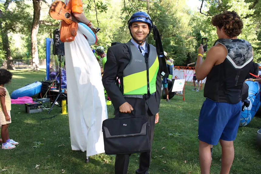 Man poses in buisness attire.