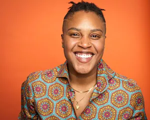 A woman smiles.