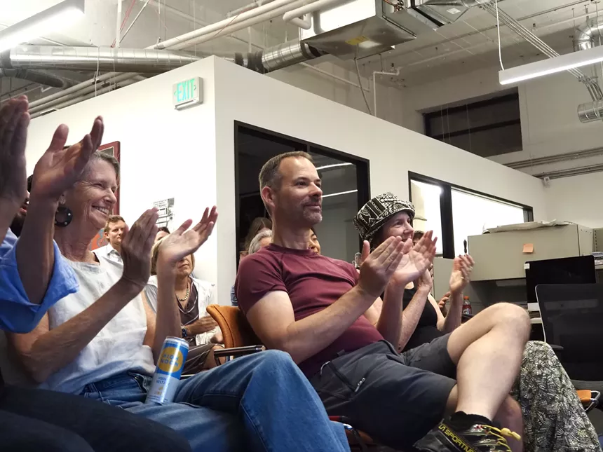 people clapping in an office space