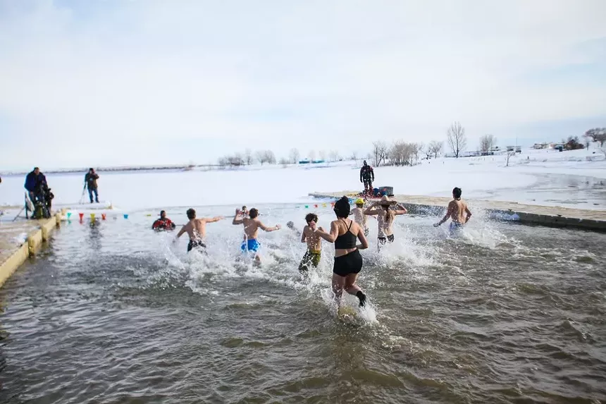 People run into the water