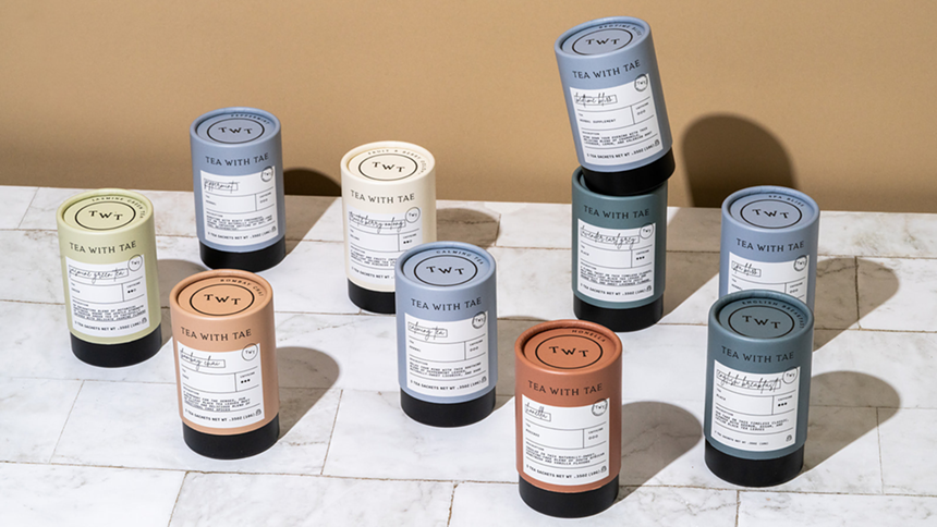 Several Tea with Tae tubes stacked and resting on a white tile counter