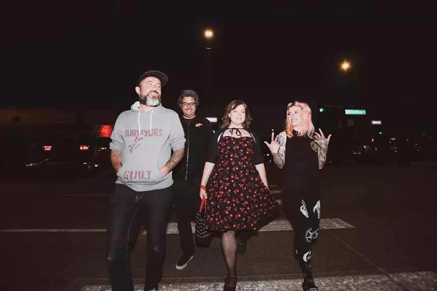 Four people standing in a line