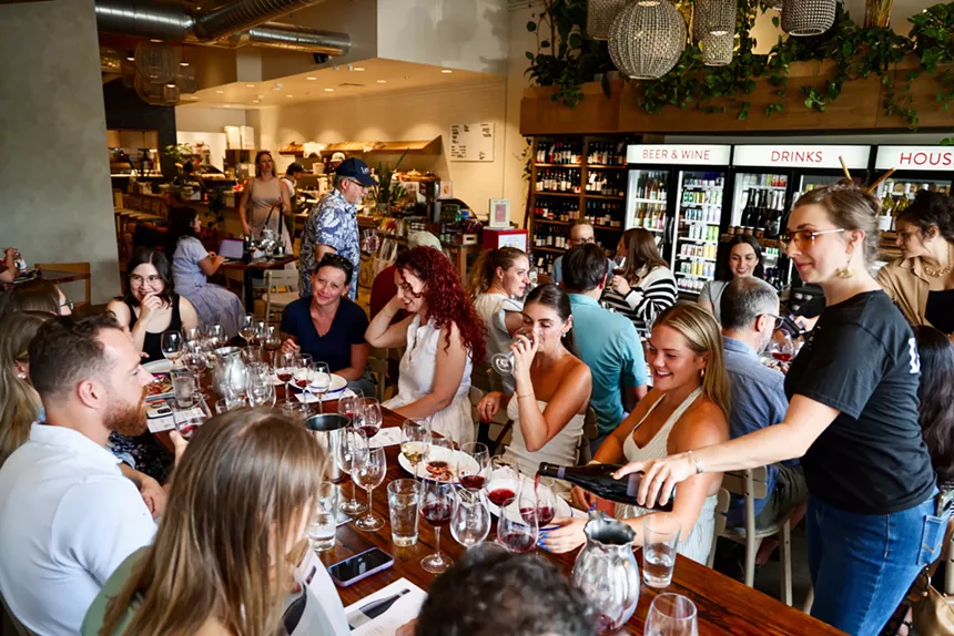 people tasting wine