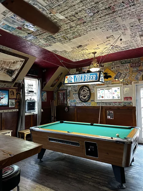 Pool table in a bar under a light
