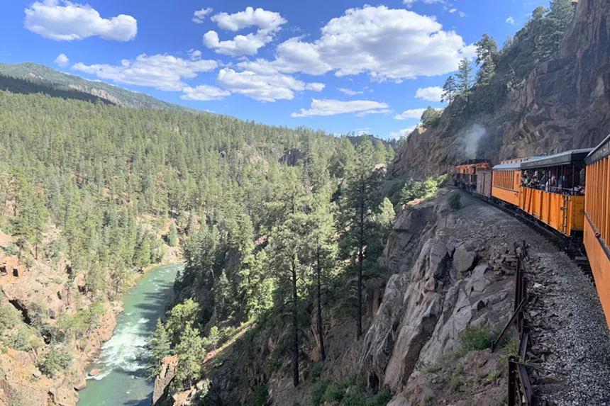 The Durango & Silverton Narrow Gauge Railroad train traveling on a cliff above the Animas River