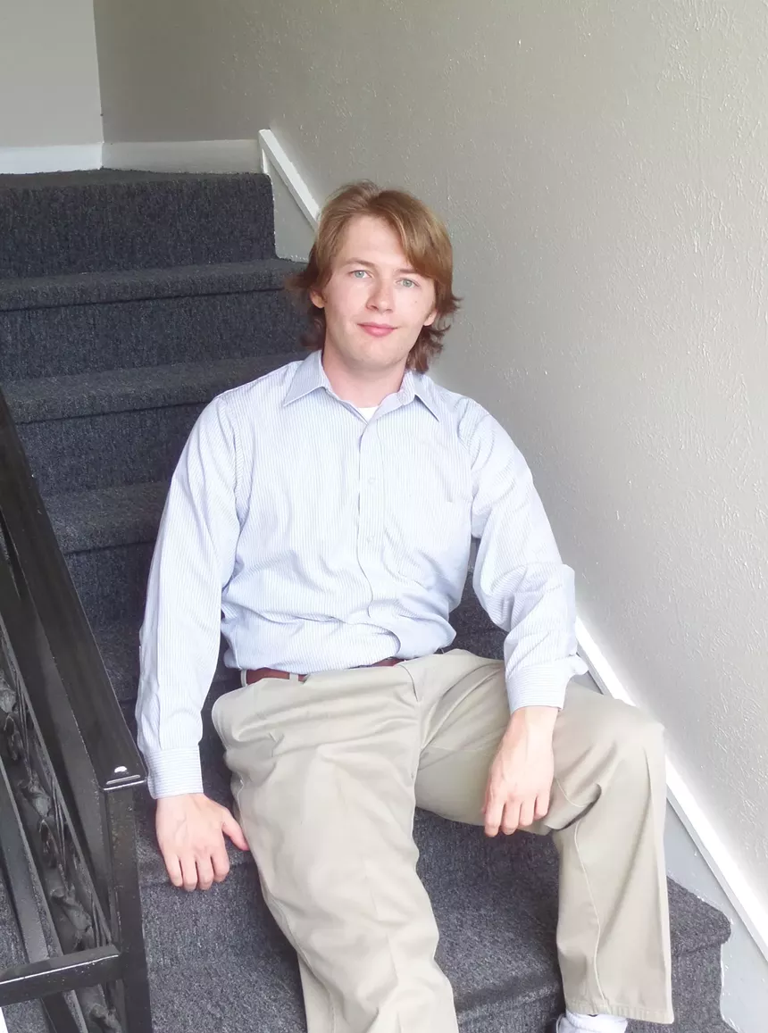 young man sits on stairs