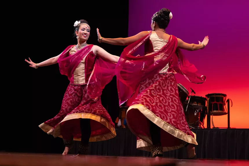 Dancers perform onstage.