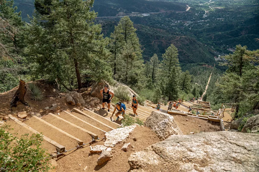 Hikers climbing up the Manitou Incline, a steep outdoor staircase