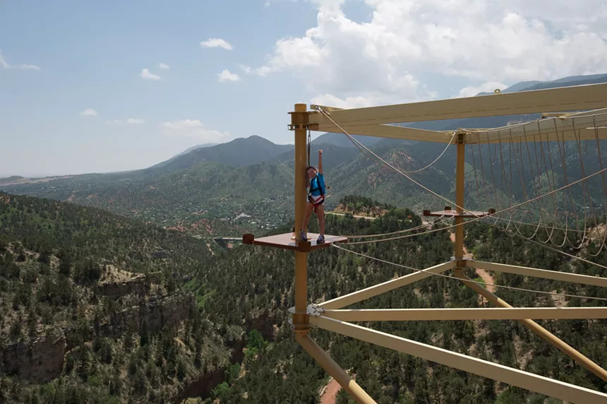 A child posed on the ropes course at Cave of the Winds Mountain Park