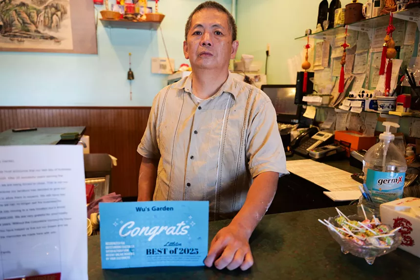 restaurant owner behind counter