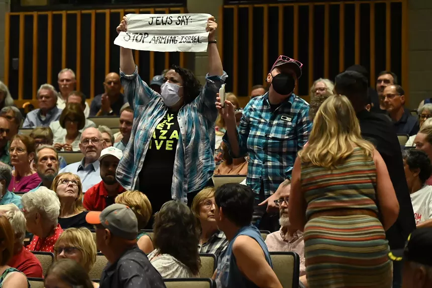A protester holds up a sign.