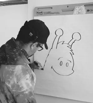 A man draws on a board
