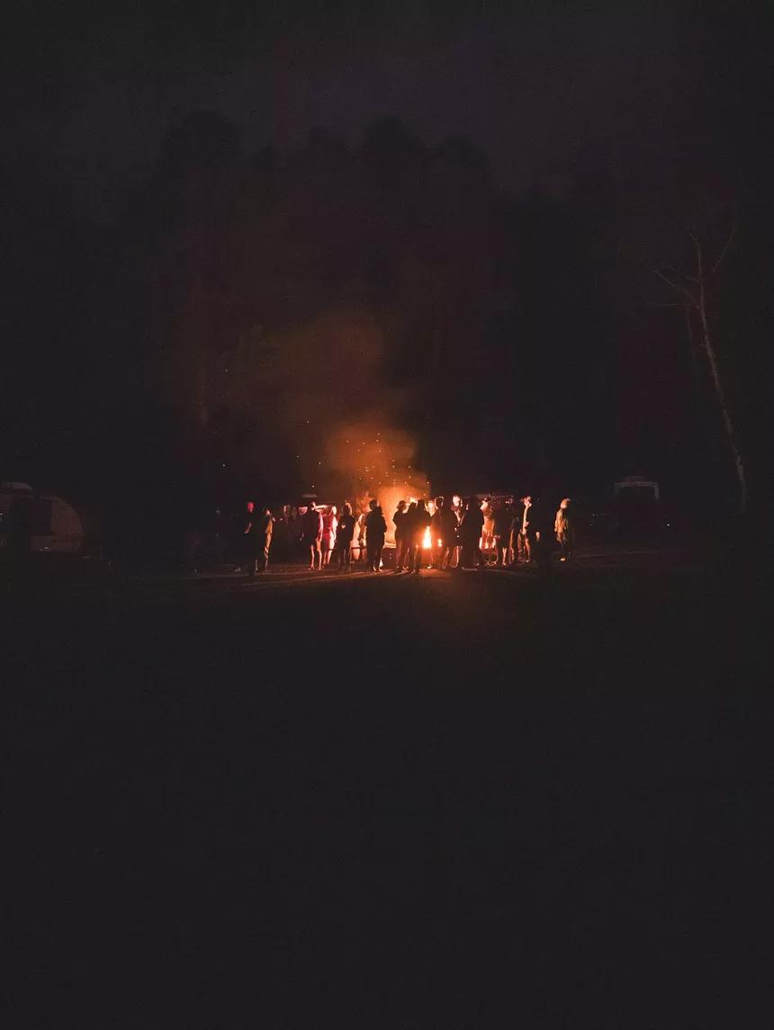people gathered around a bonfire