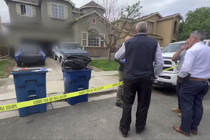 Police standing outside of a home on a residential street in Commerce City.