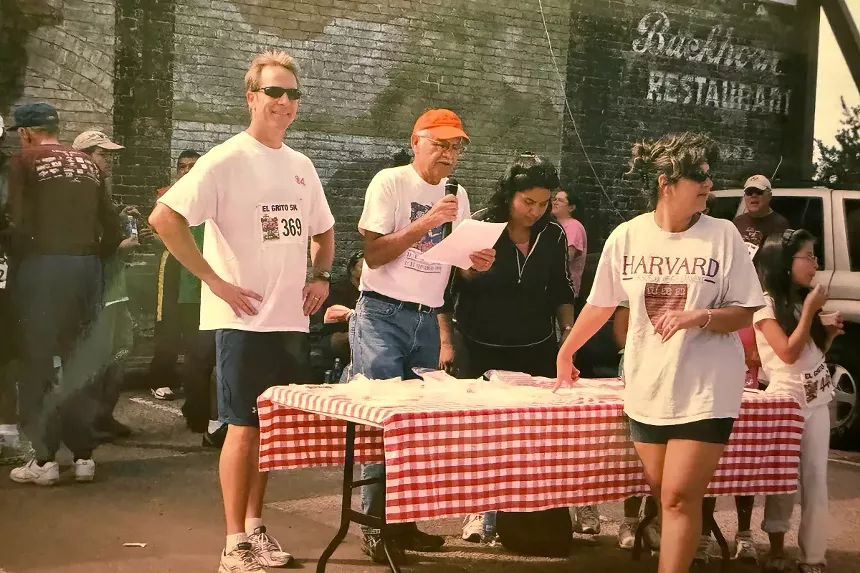 Rich Romero announces the runner results of the El Grito 5K.