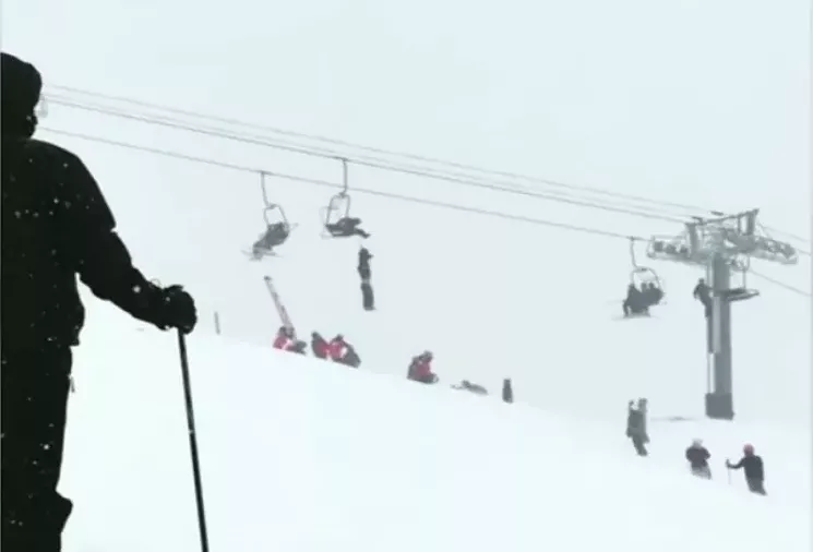 Richard hanging from the chairlift. - ELLEN VIA YOUTUBE