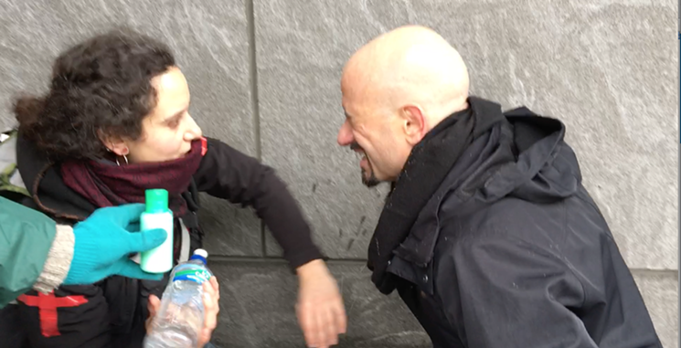 Denver attorney Jason Flores-Williams gets treated after being sprayed by chemicals in the face by police officers. - CHRIS WALKER